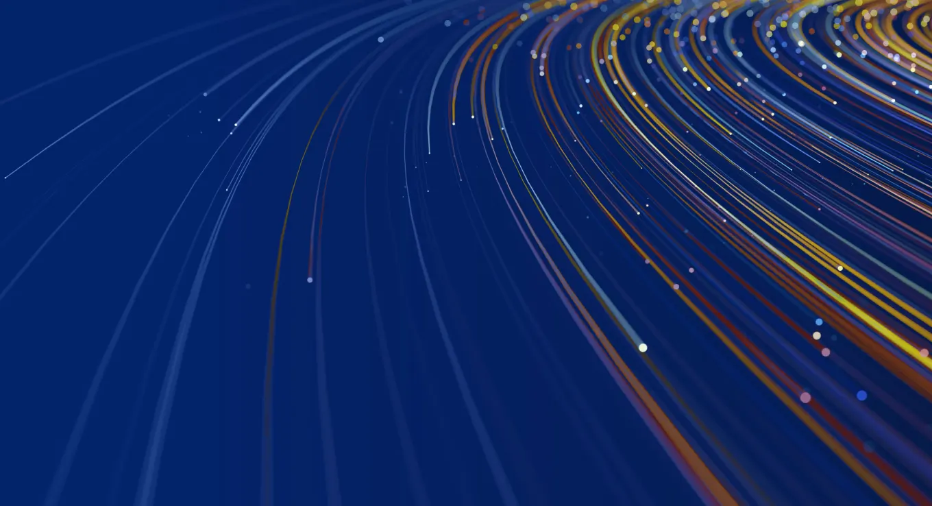 Abstract, high-tech growing spiral lines of blue, orange, and yellow with specks of white