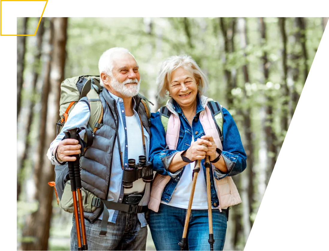 Smiling older couple hiking in the woods